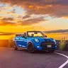 Blue Mini Cooper S convertible at sunset in Kona