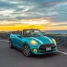 Teal Mini Cooper convertible on the Kona coast road