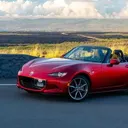 Red Mazda MX-5 Miata convertible with the top down